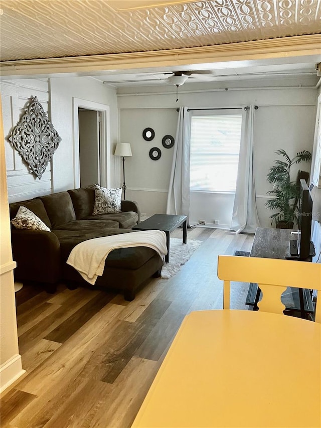 living room featuring wood-type flooring and ceiling fan