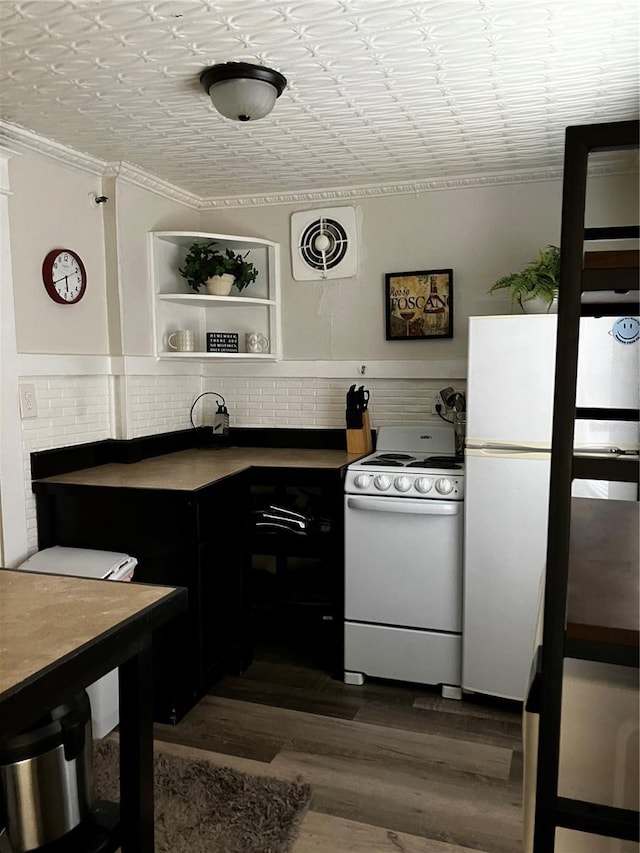 kitchen featuring dark hardwood / wood-style floors, white appliances, and ornamental molding