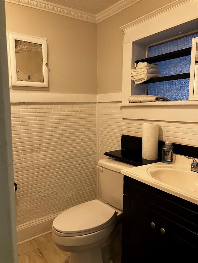 bathroom with tile patterned flooring, vanity, and toilet