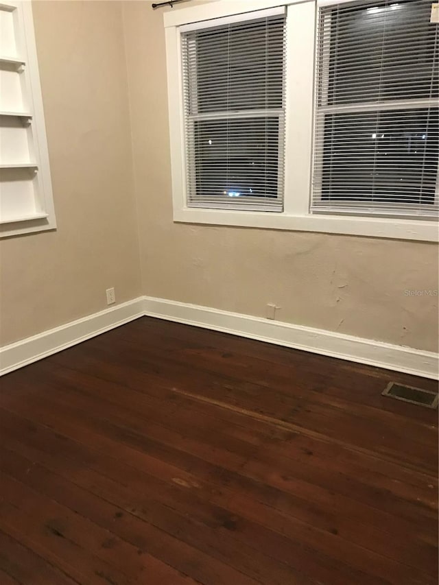 spare room featuring dark hardwood / wood-style floors