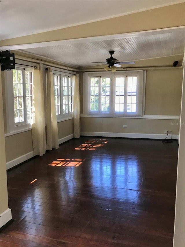 unfurnished room featuring plenty of natural light, ceiling fan, and dark hardwood / wood-style flooring