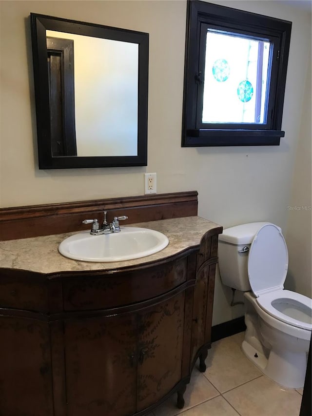 bathroom with tile patterned floors, vanity, and toilet