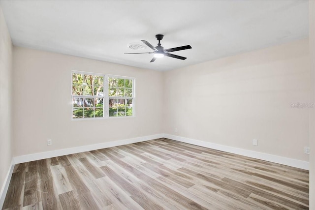 empty room with light wood-style floors, baseboards, and a ceiling fan