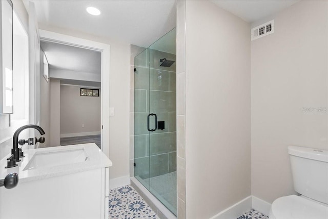 bathroom with toilet, a stall shower, visible vents, and baseboards