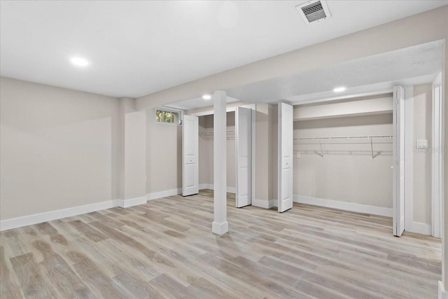 basement with baseboards, recessed lighting, visible vents, and light wood-style floors