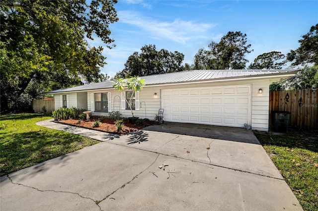 ranch-style home with a garage and a front yard