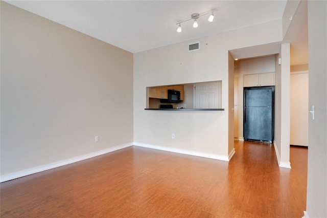 unfurnished living room with wood-type flooring