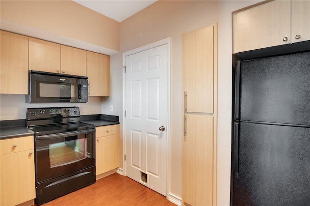 kitchen featuring light brown cabinetry, black appliances, and light hardwood / wood-style flooring