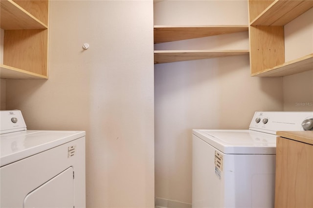 clothes washing area featuring independent washer and dryer