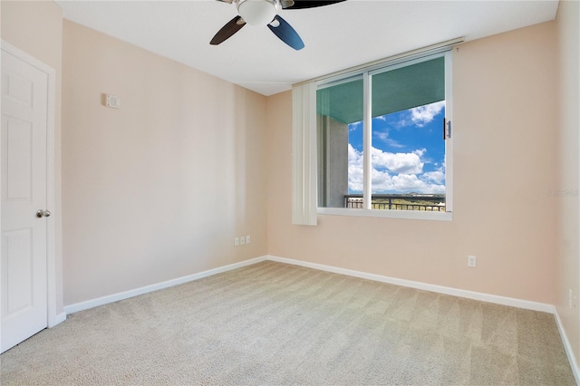 empty room with ceiling fan and carpet floors