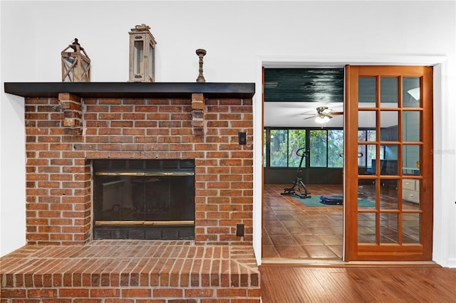 details featuring hardwood / wood-style floors, ceiling fan, and a fireplace