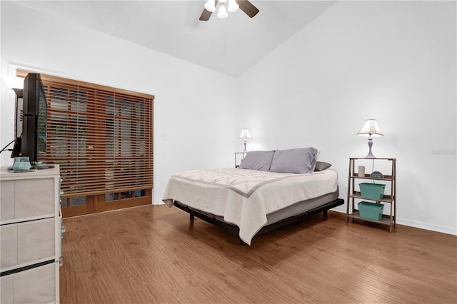 bedroom with vaulted ceiling, ceiling fan, and hardwood / wood-style flooring