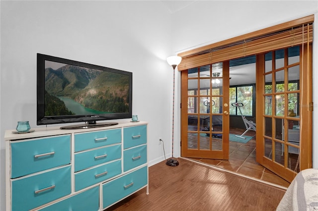 living area with dark hardwood / wood-style flooring and french doors