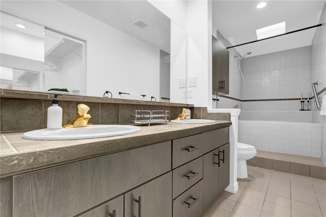 bathroom featuring vanity, toilet, and tile patterned floors