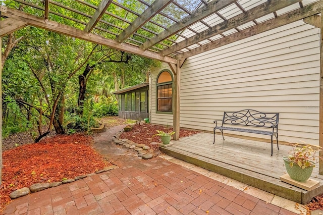 view of patio / terrace with a sunroom and a pergola