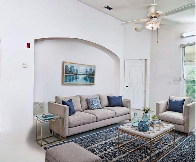 living room with ceiling fan and vaulted ceiling