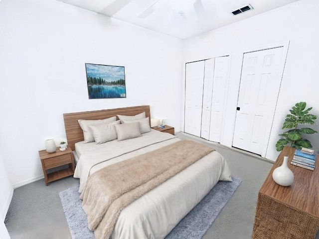 bedroom with light carpet, ceiling fan, and multiple closets