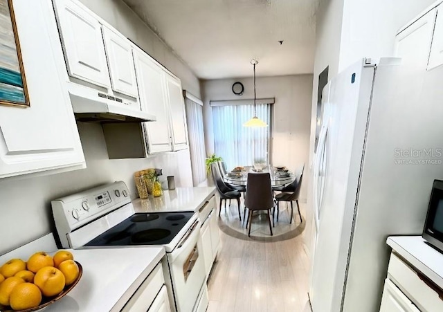 kitchen with white cabinetry, pendant lighting, white electric range oven, and light hardwood / wood-style flooring