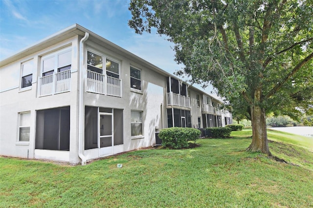 view of side of property with a yard