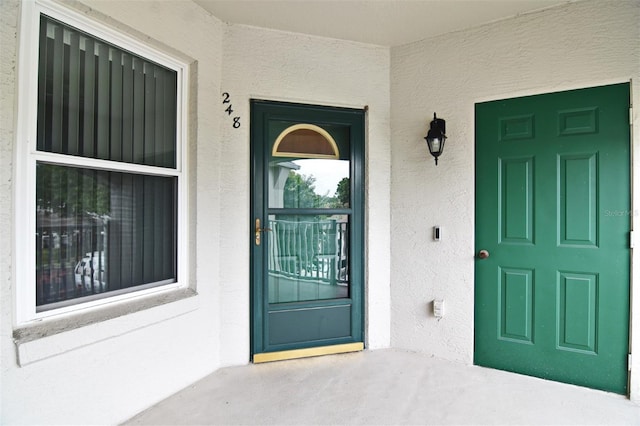 570 Cranes Way Unit 248, Altamonte Springs, FL 32701 - view of exterior entry with stucco siding and covered porch