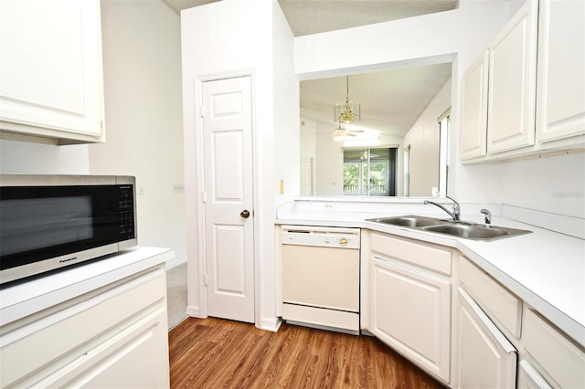 570 Cranes Way Unit 248, Altamonte Springs, FL 32701 - kitchen with dishwasher, a sink, light wood-style flooring, light countertops, and white cabinetry