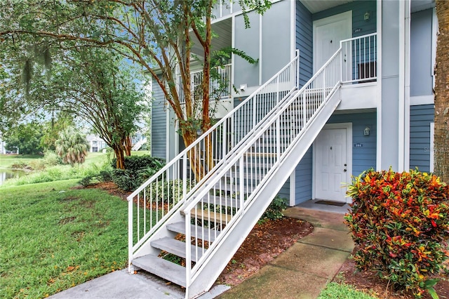 view of exterior entry featuring a lawn