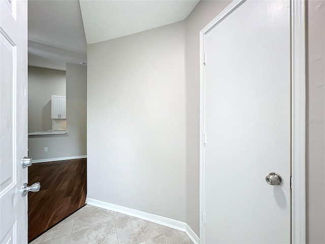 hall featuring light tile patterned flooring