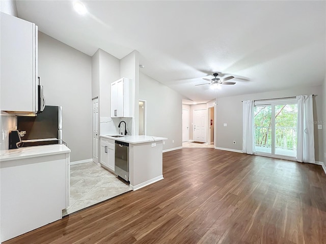 kitchen with light hardwood / wood-style flooring, stainless steel appliances, white cabinetry, and ceiling fan