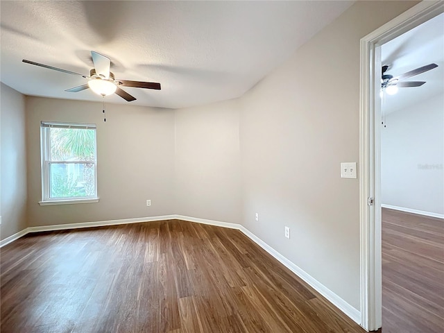 unfurnished room featuring ceiling fan, dark hardwood / wood-style floors, and a textured ceiling