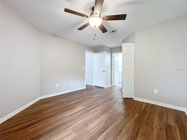 empty room with a textured ceiling, ceiling fan, and hardwood / wood-style flooring