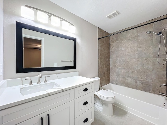 full bathroom with vanity, tiled shower / bath combo, a textured ceiling, tile patterned floors, and toilet