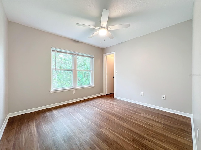 spare room featuring hardwood / wood-style floors and ceiling fan