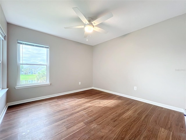 spare room with ceiling fan and dark hardwood / wood-style floors