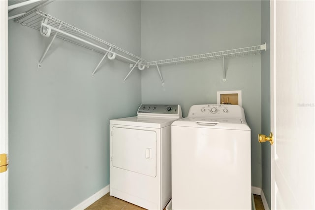 laundry room featuring washer and dryer and light tile patterned floors