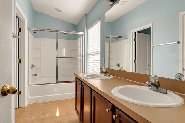 bathroom featuring tile patterned flooring, vanity, lofted ceiling, and bath / shower combo with glass door