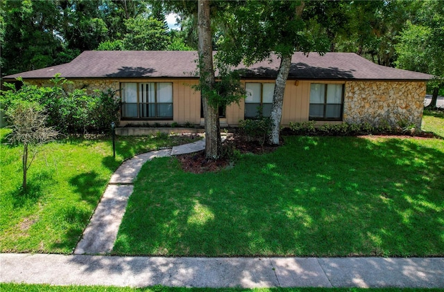 ranch-style house with a front lawn