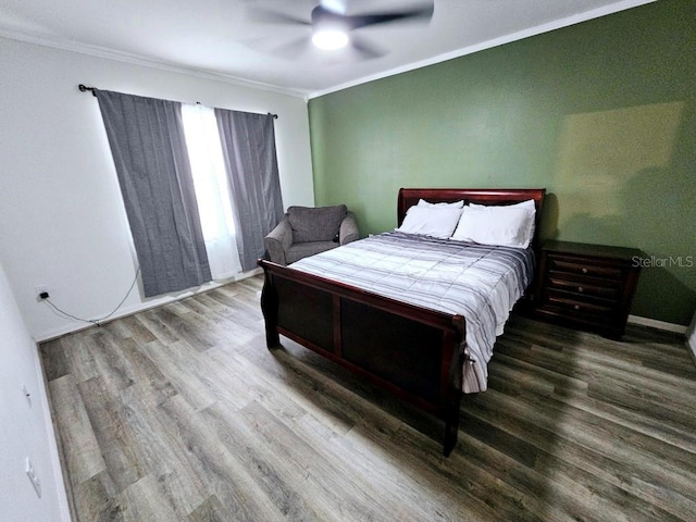 bedroom featuring ornamental molding, wood-type flooring, and ceiling fan