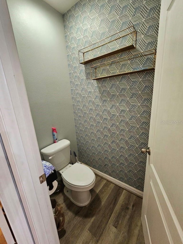 bathroom with hardwood / wood-style floors and toilet