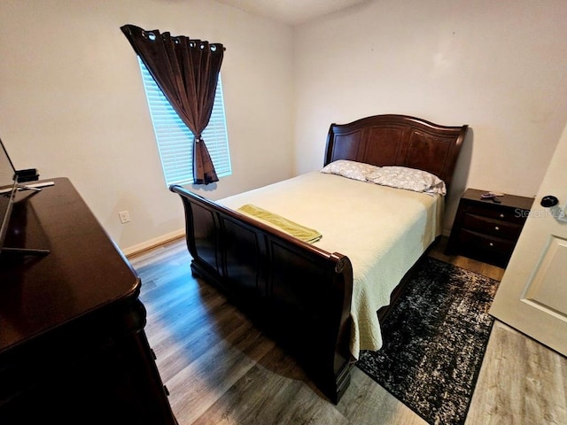 bedroom featuring dark hardwood / wood-style flooring