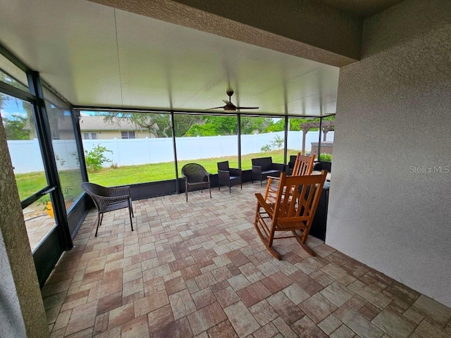 sunroom featuring ceiling fan