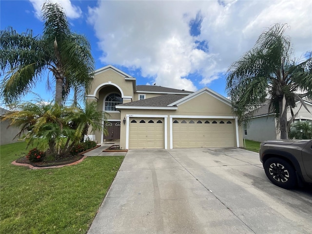 view of front facade with a garage and a front yard