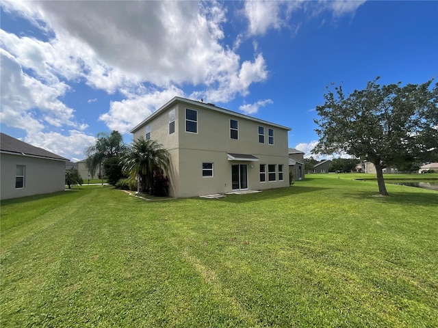 back of house with a yard