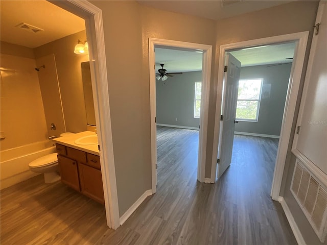 full bathroom featuring vanity, toilet, ceiling fan, and hardwood / wood-style flooring