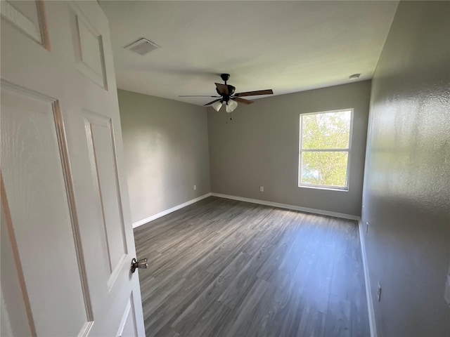 unfurnished room with dark hardwood / wood-style floors and ceiling fan