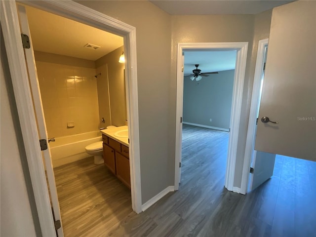 full bathroom with vanity, toilet, and hardwood / wood-style flooring