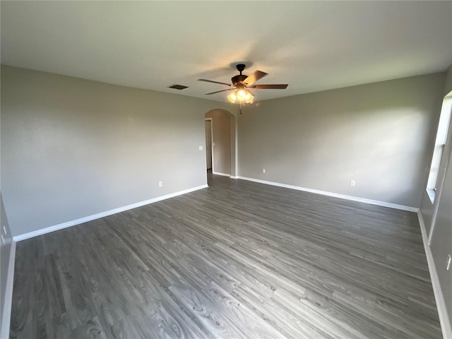 spare room featuring ceiling fan and dark wood-type flooring