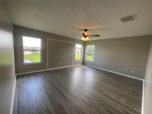 unfurnished room with ceiling fan and dark hardwood / wood-style floors