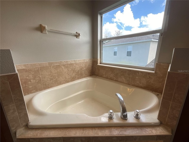 bathroom featuring tiled bath