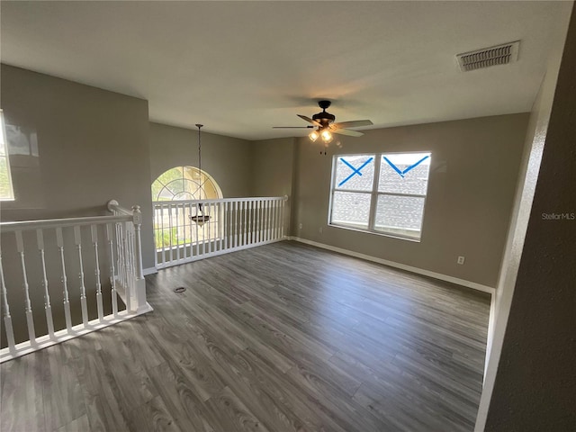 spare room with ceiling fan and dark hardwood / wood-style floors