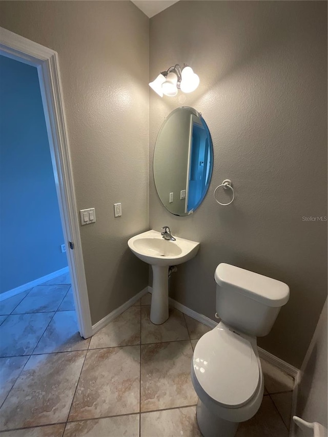 bathroom with tile patterned floors and toilet